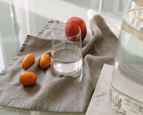 Home dining table with fruit and glass of water