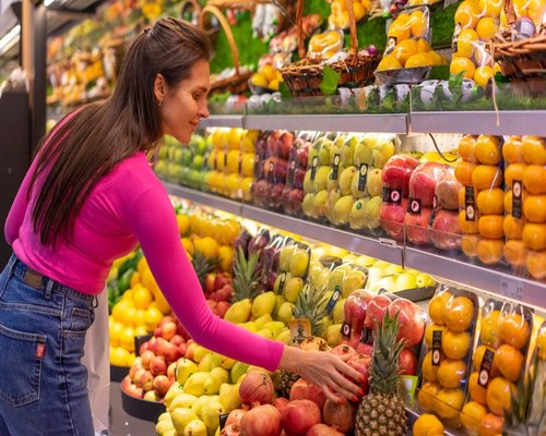 Person buying local fresh fruit at a neighborhood store